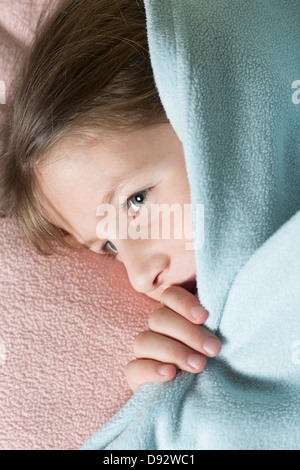 Girl under blanket Stock Photo