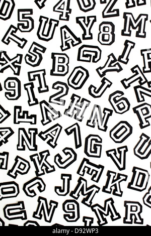 A bunch of varsity font sticker letters and numbers in black outline Stock Photo