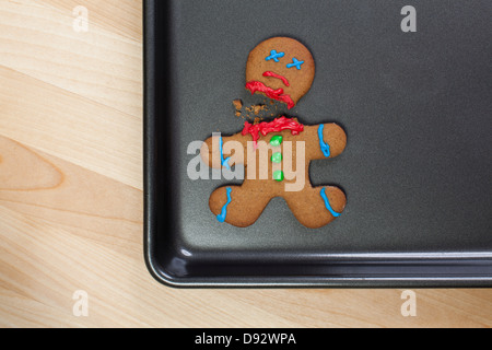 A decapitated gingerbread man on a baking sheet Stock Photo