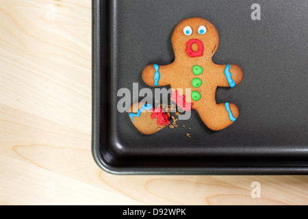 A gingerbread man looking shocked with a broken leg Stock Photo