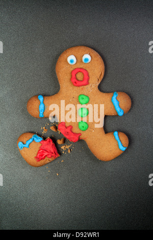 A gingerbread man looking shocked with a broken leg Stock Photo