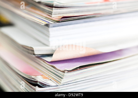 A messy stack of well thumbed through magazines Stock Photo