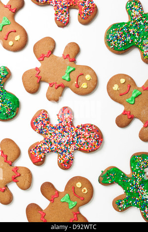 Various decorated gingerbread men cookies arranged on a white background Stock Photo