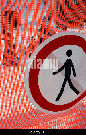 No pedestrian sign hanging on a mesh barrier Stock Photo