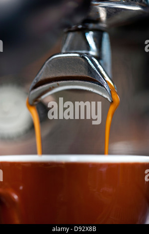 A double shot of espresso being poured from an espresso maker Stock Photo