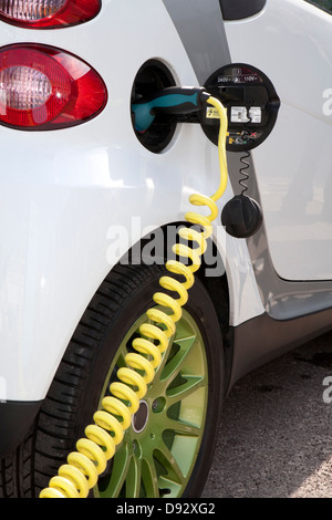 Detail of a charger connected to an electric car recharging Stock Photo