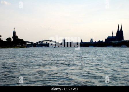 Distinctive Cologne cityscape in silhouette seen from the Rhine river Stock Photo