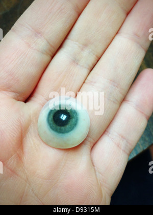 Close up of glass eye in hand Stock Photo