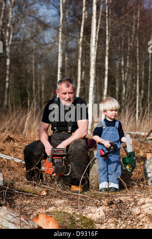 Grandfather with grandson in forest Stock Photo