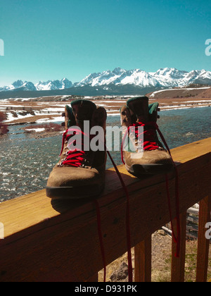 Hiking boots on snowy balcony Stock Photo