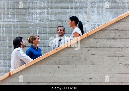 Men and women talking on stairs Stock Photo