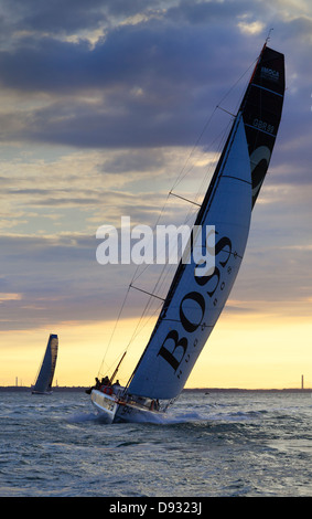 Alex Thomson Racing an Open 60 monohull in a Farr-designed race boat at sunrise Stock Photo