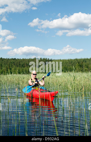Woman kayaking on lake Stock Photo