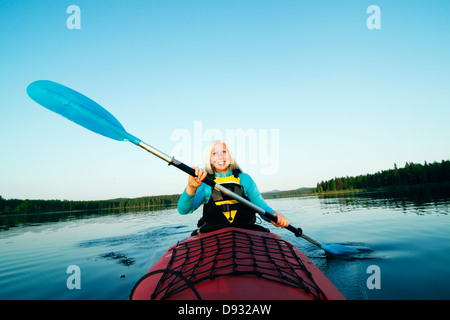 Smiling woman holding paddle Stock Photo