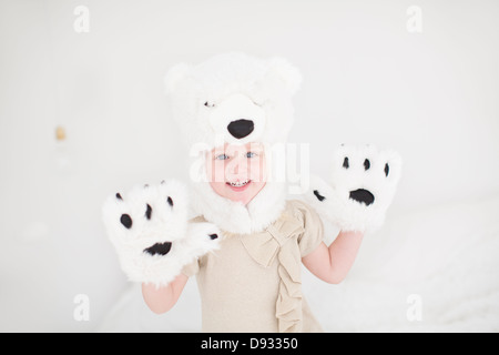 Portrait of little girl wearing polar bear costume Stock Photo