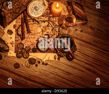 Border of pirates booty on wooden background, stolen treasure still life on the table in filibuster room Stock Photo