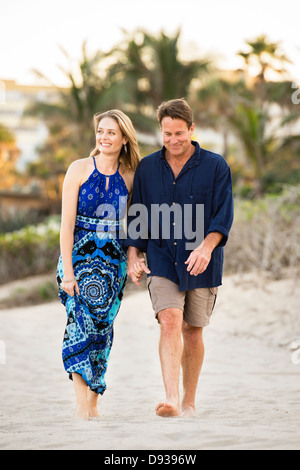 Couple walking together on beach Stock Photo