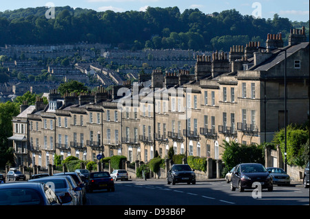 A row of houses in Bath with view of city behind.