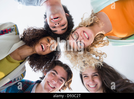 Friends huddled in circle together Stock Photo