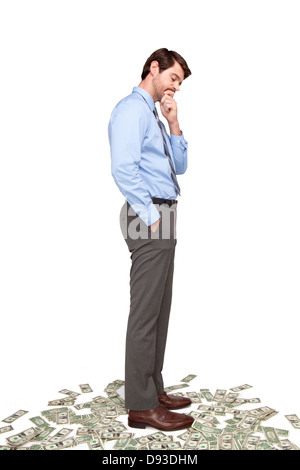 Caucasian businessman standing on money Stock Photo
