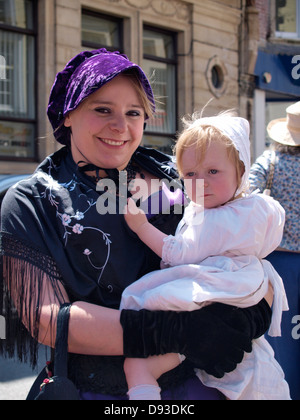 Woman with baby, Ilfracombe Victorian Celebration Parade, Devon, UK 2013 Stock Photo