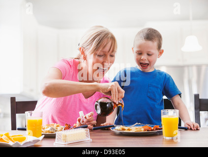 Caucasian mother and son having breakfast Stock Photo