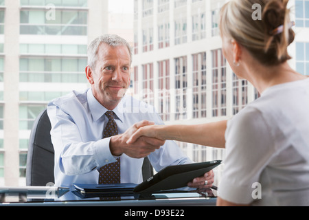 Caucasian businessman shaking hands with client Stock Photo