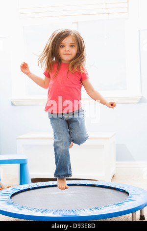 Caucasian girl jumping on trampoline