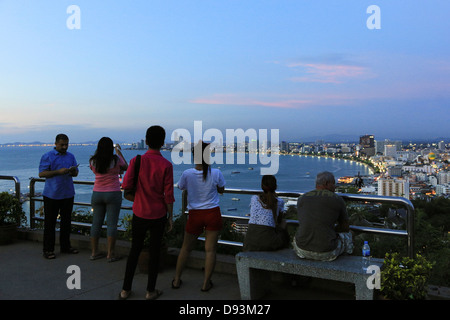 Tourists enjoying the sunset over Pattaya bay and cityscape from above, Thailand Stock Photo