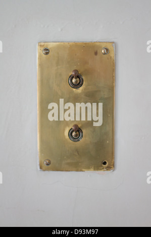 Old fashioned double brass light switch Stock Photo