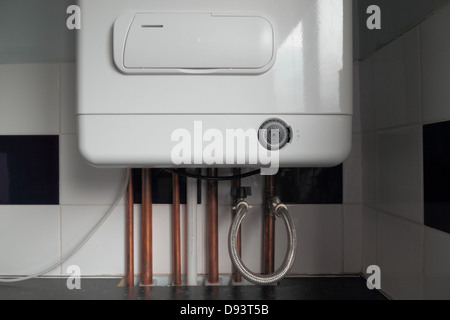 Combi Condensing Gas Boiler, with analogue timer dial. Exposed copper piping. Stock Photo