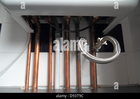 Combi Condensing Gas Boiler, with analogue timer dial. Exposed copper piping. Stock Photo