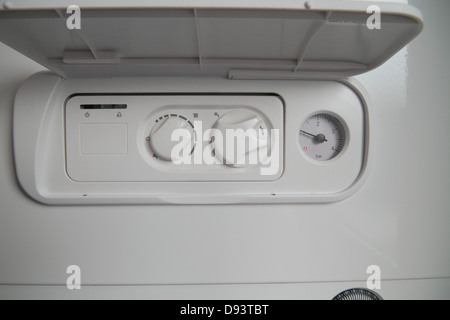 Combi Condensing Gas Boiler, with analogue timer dial. Exposed copper piping. Stock Photo