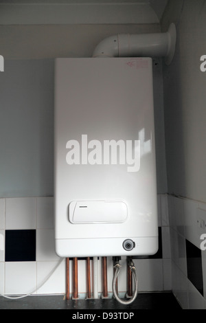 Combi Condensing Gas Boiler, with analogue timer dial. Exposed copper piping. Stock Photo