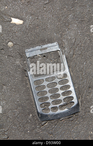 item embedded in hot tarmac road surface in sun Stock Photo