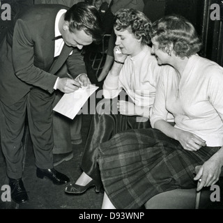 MATT MONRO (1930-1985) UK singer signs autographs about 1959 Stock Photo