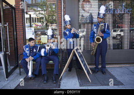 MEMBERS OF A HIGH SCHOOL MARCHING BAND WARM UP TO MARCH IN THE MEMORIAL DAY PARADE IN BAY RIDGE BROOKLYN, NYC Stock Photo