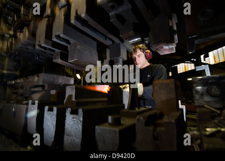 A worker in an axe smithy, Sweden. Stock Photo