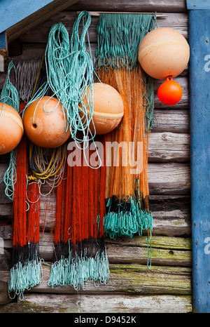 Buoys and fishing nets hanging on wooden wall Stock Photo