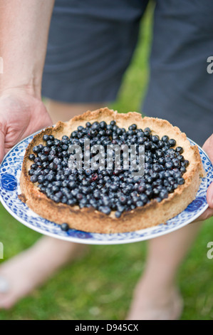 Man holding blueberry pie Stock Photo