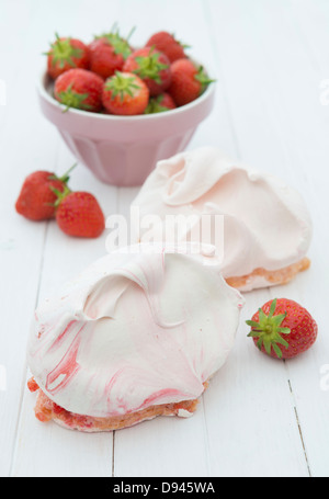 Strawberries in a pink bowl with large strawberry meringues Stock Photo