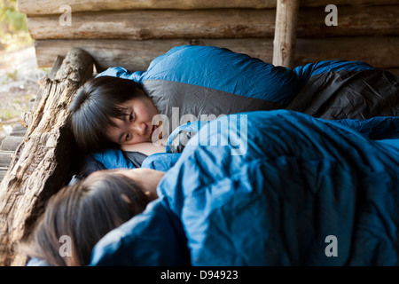 Two female tourists sleeping in shelter Stock Photo