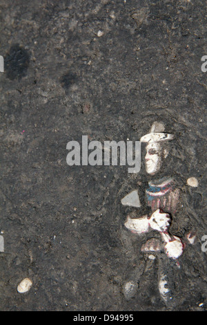 item embedded in hot tarmac road surface in sun Stock Photo