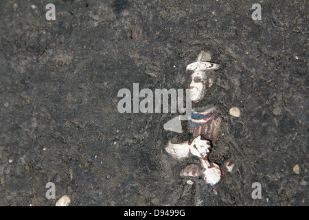 item embedded in hot tarmac road surface in sun Stock Photo