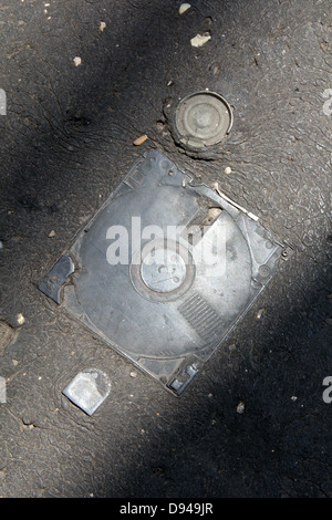 item embedded in hot tarmac road surface in sun Stock Photo