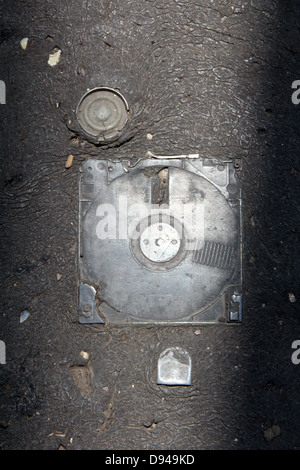 item embedded in hot tarmac road surface in sun Stock Photo