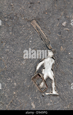 item embedded in hot tarmac road surface in sun Stock Photo