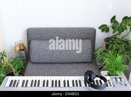 Electric piano and comfortable armchair for a musician. Stock Photo