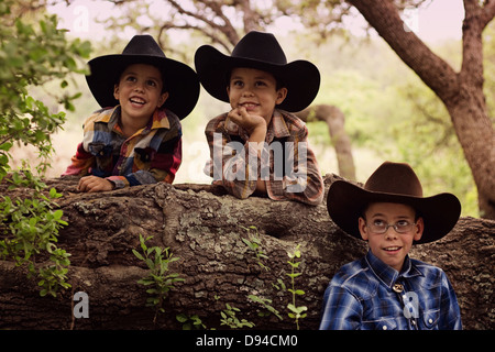 Three little boys dressed up like cowboys Stock Photo