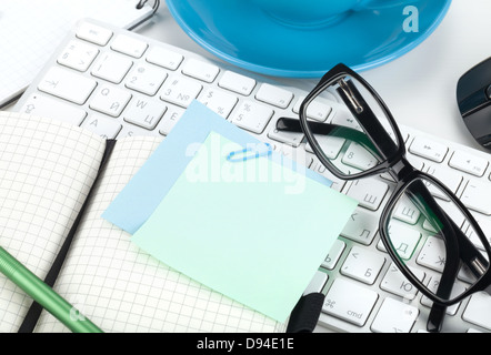 Office supplies, glasses and computer keyboard closeup Stock Photo